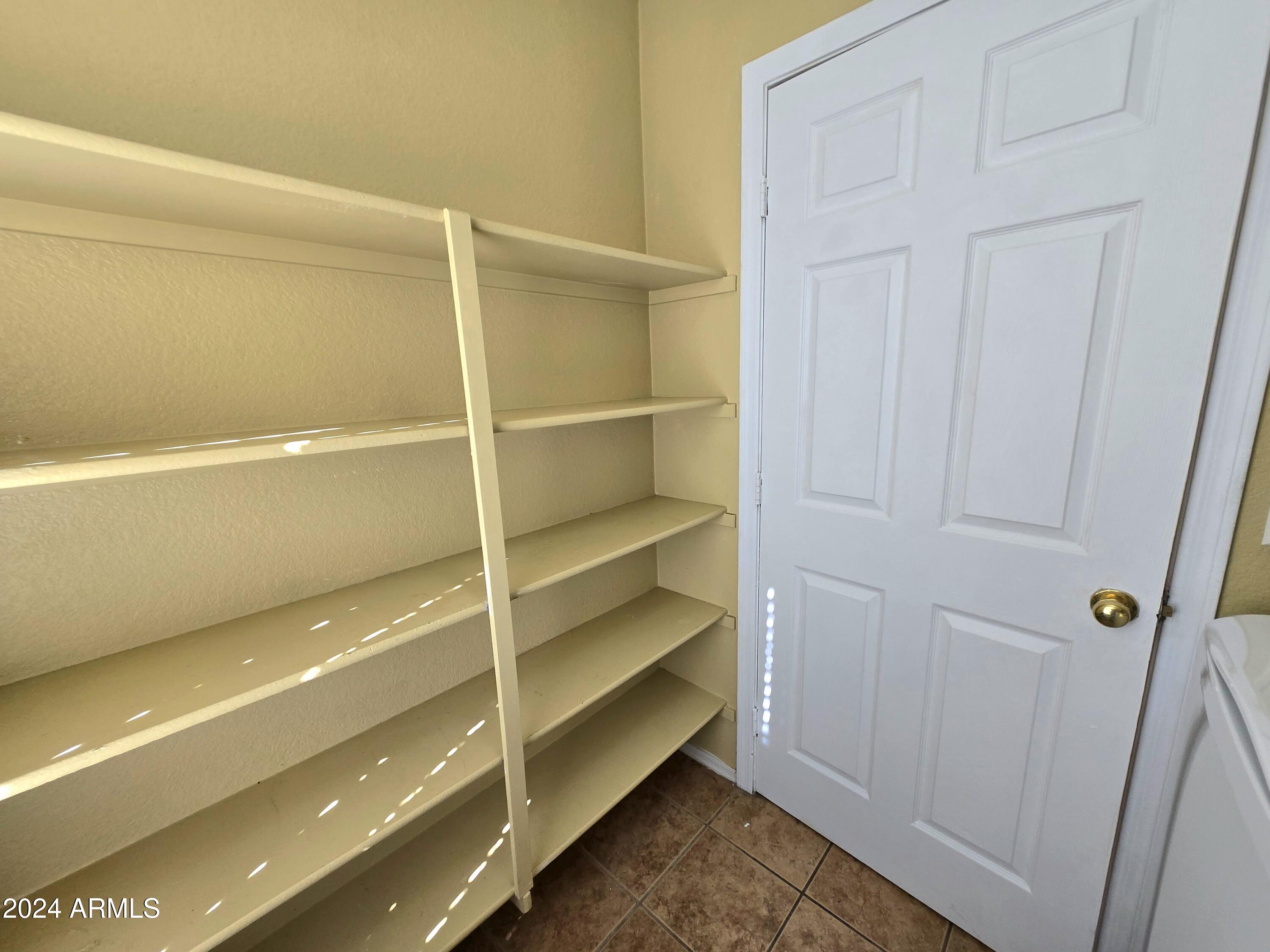 9365 West Eaton Road Phoenix, AZ 85037 - Photo 18 of 30 a view of walk in closet with empty racks