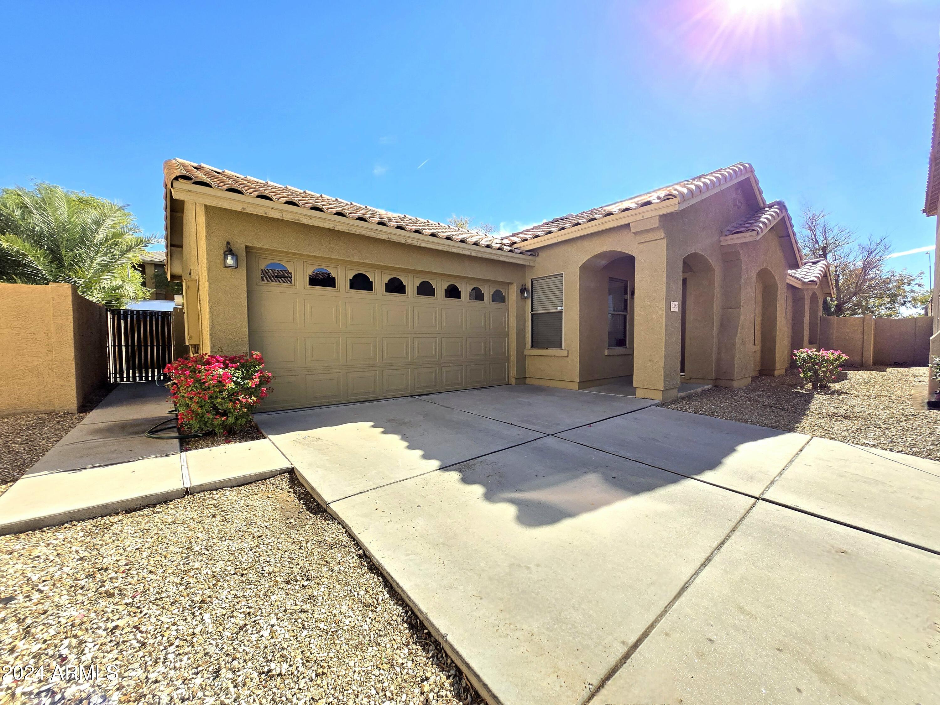 9365 West Eaton Road Phoenix, AZ 85037 - Photo 2 of 30 a front view of a house with a garage