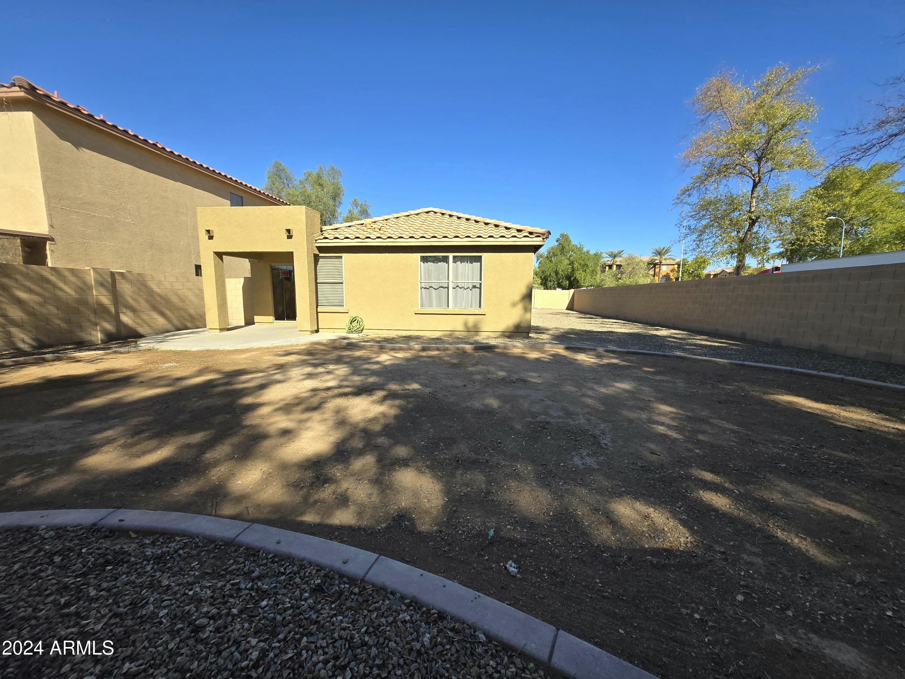 9365 West Eaton Road Phoenix, AZ 85037 - Photo 21 of 30 a view of a house with a yard