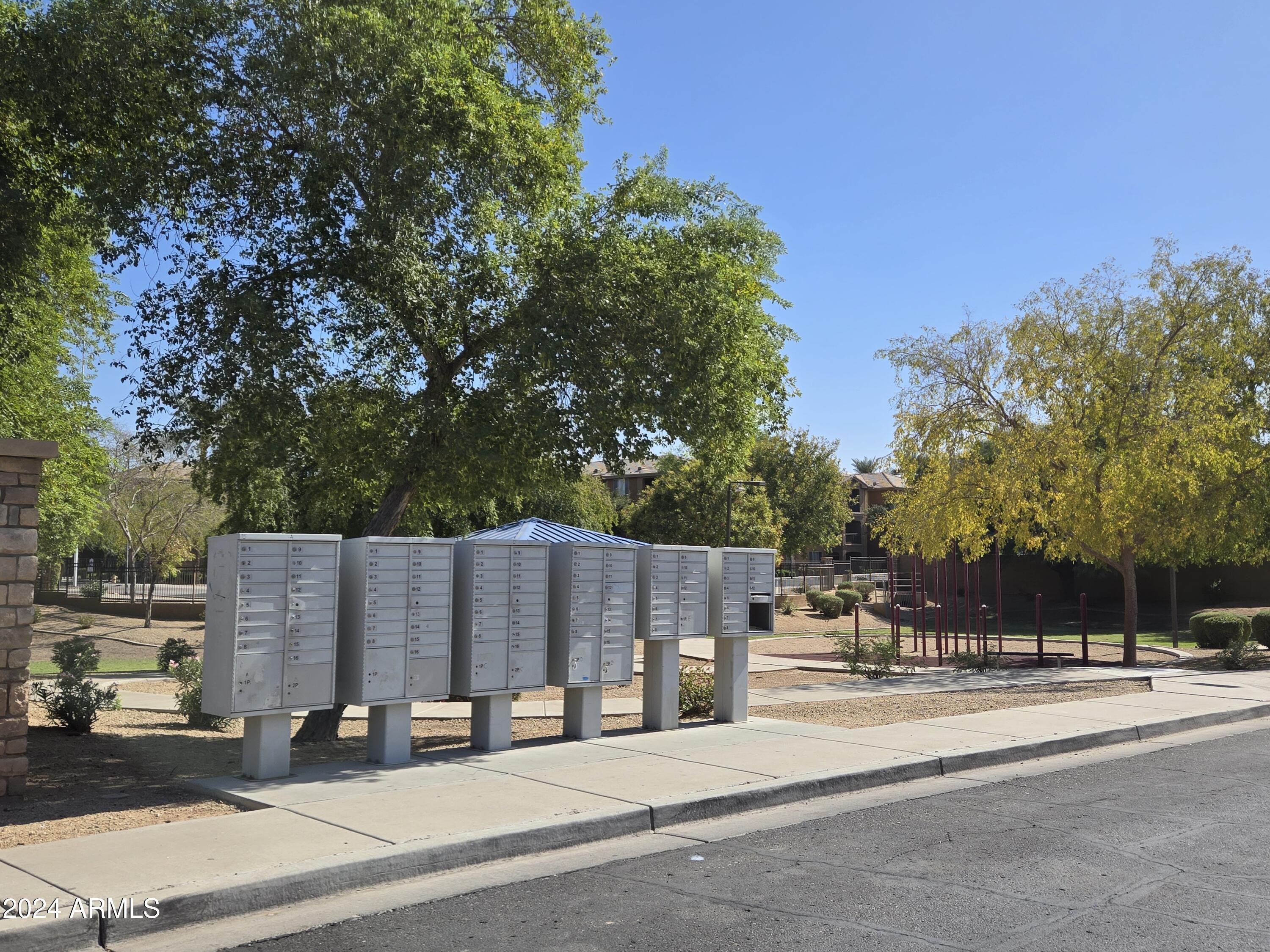 9365 West Eaton Road Phoenix, AZ 85037 - Photo 26 of 30 a view of street with houses and trees in the background