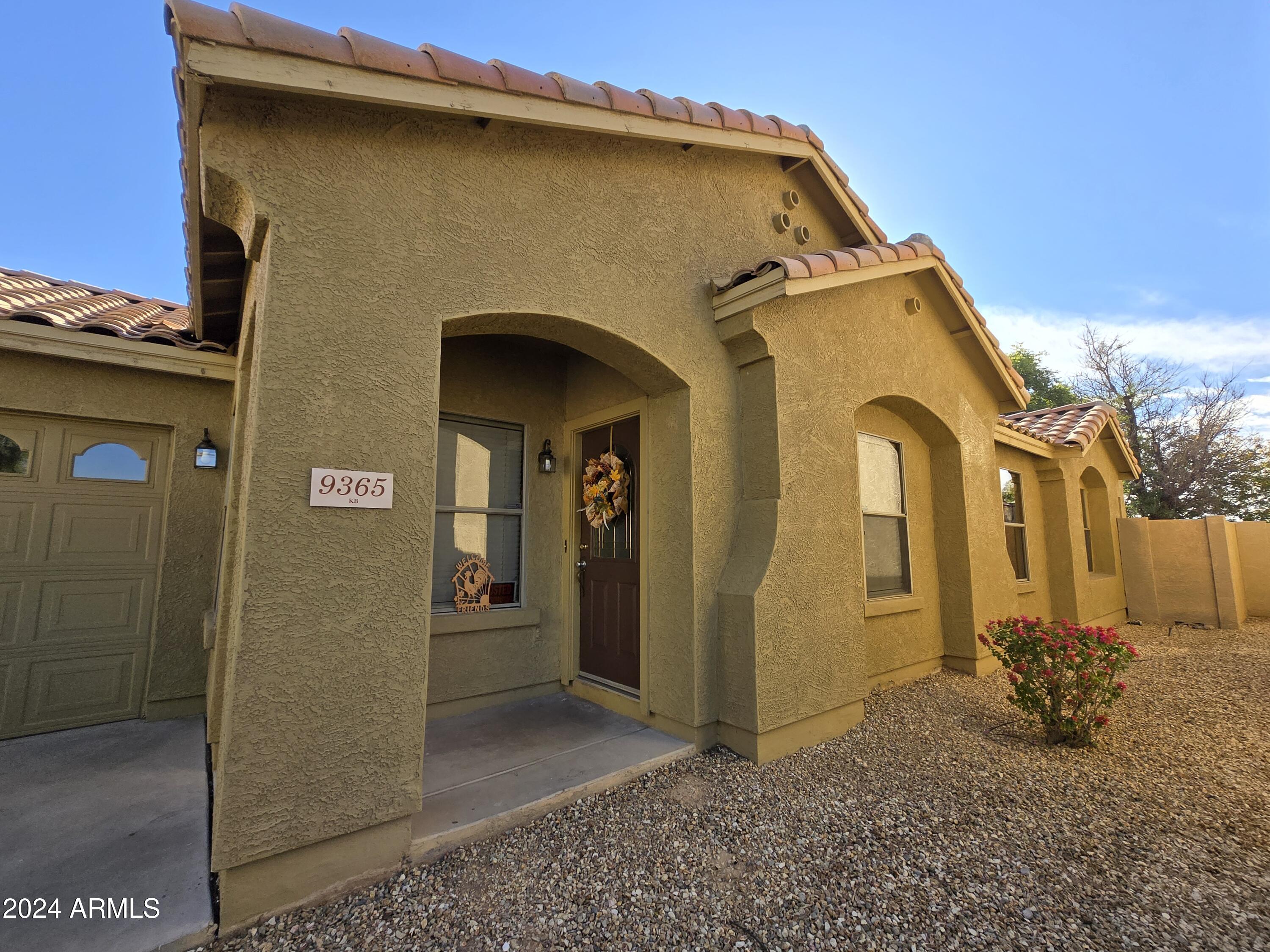 9365 West Eaton Road Phoenix, AZ 85037 - Photo 4 of 30 a front view of a house with a yard