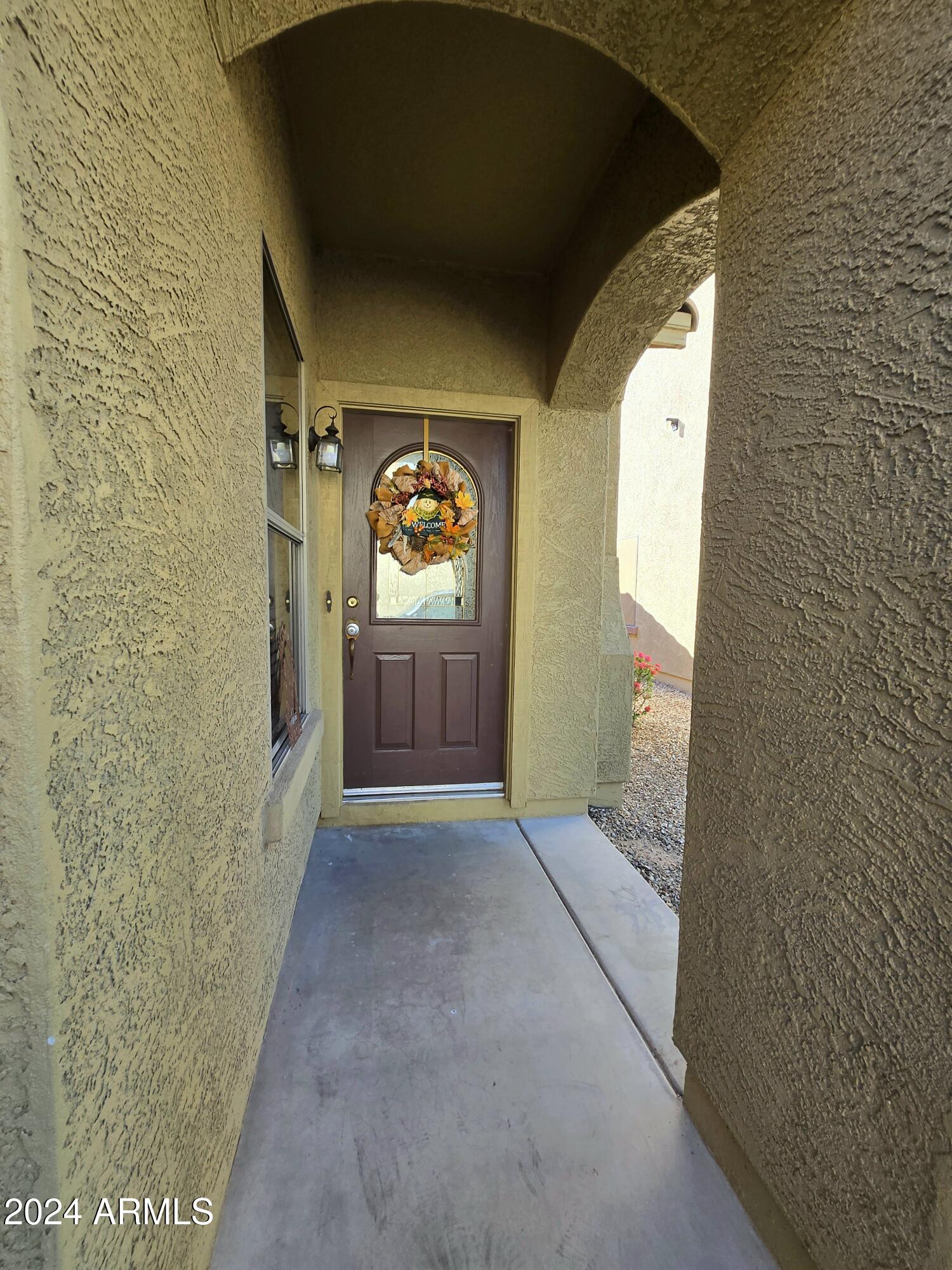 9365 West Eaton Road Phoenix, AZ 85037 - Photo 5 of 30 a view of a hallway with wooden floor and a bathroom