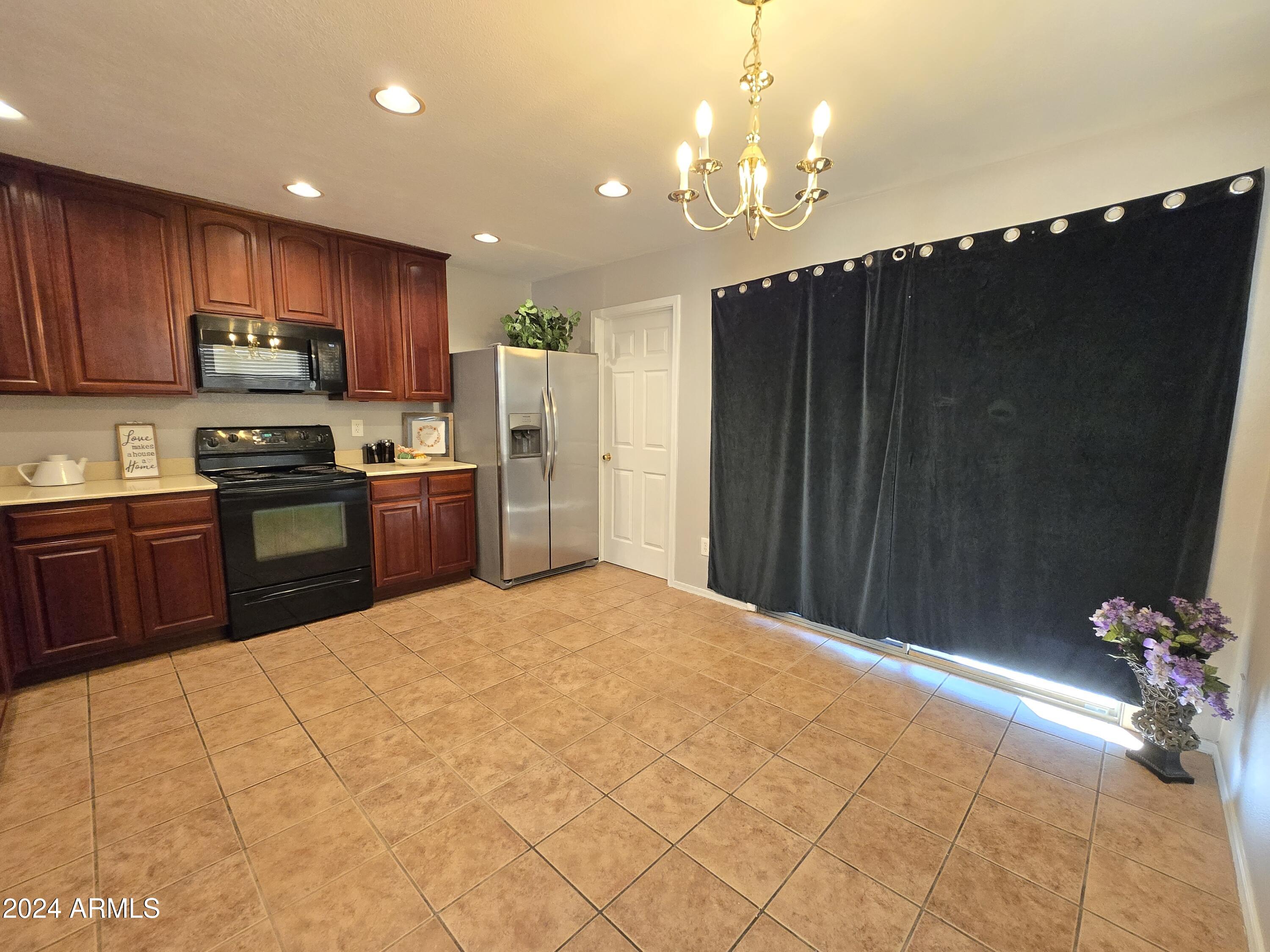 9365 West Eaton Road Phoenix, AZ 85037 - Photo 7 of 30 a kitchen with stainless steel appliances granite countertop a refrigerator sink and cabinets