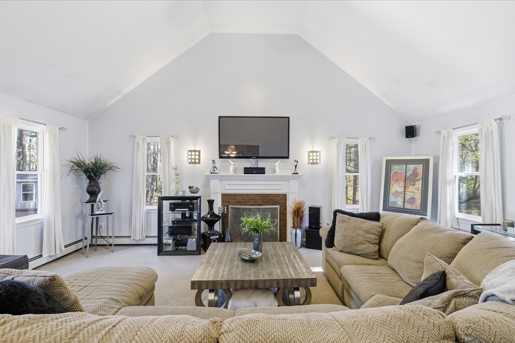 116 Meadow Street Carver, MA 02330 - Photo 13 of 42 a living room with furniture and a fireplace