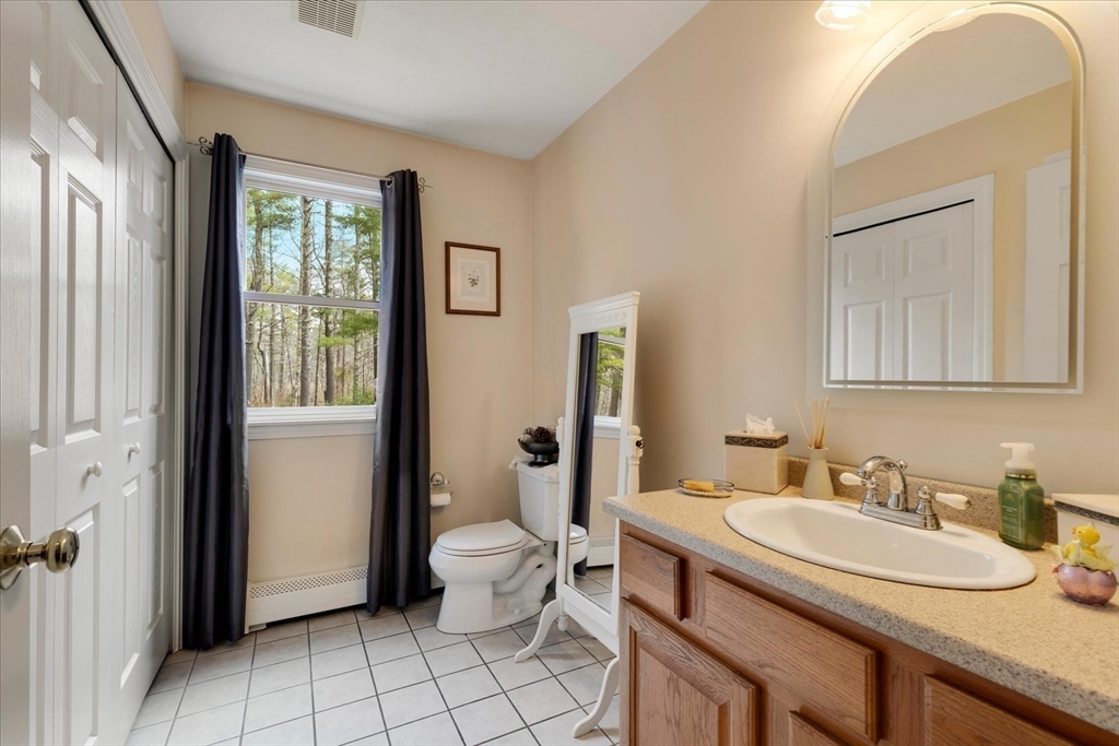 116 Meadow Street Carver, MA 02330 - Photo 20 of 42 a bathroom with a granite countertop sink and a mirror