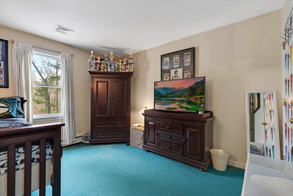 116 Meadow Street Carver, MA 02330 - Photo 22 of 42 a living room with furniture and a flat screen tv