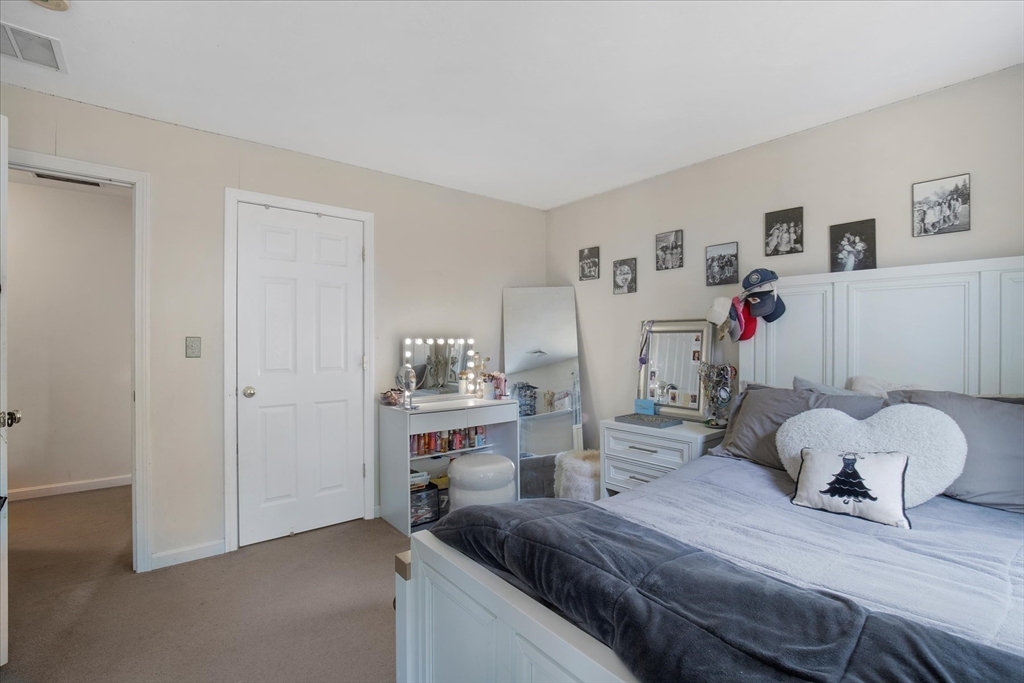 116 Meadow Street Carver, MA 02330 - Photo 25 of 42 a bedroom with a bed and a cabinets