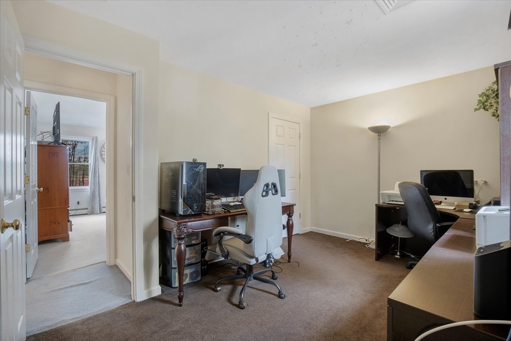 116 Meadow Street Carver, MA 02330 - Photo 28 of 42 a view of a workspace with furniture and a bedroom