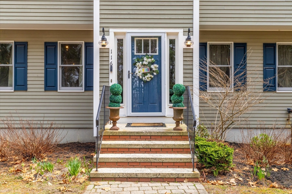 116 Meadow Street Carver, MA 02330 - Photo 3 of 42 a front view of a house with potted plants