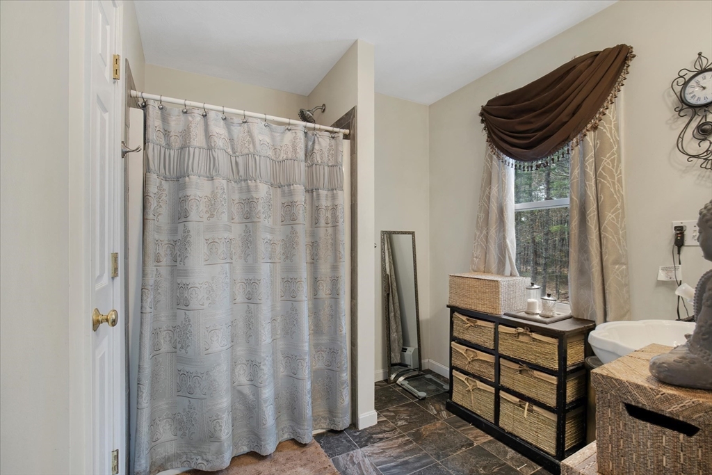 116 Meadow Street Carver, MA 02330 - Photo 31 of 42 a bathroom with a sink a mirror and a shower curtain