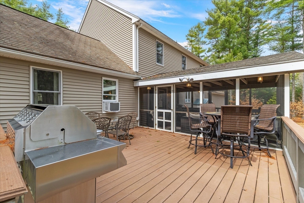 116 Meadow Street Carver, MA 02330 - Photo 34 of 42 a view of a patio with table and chairs and wooden floor