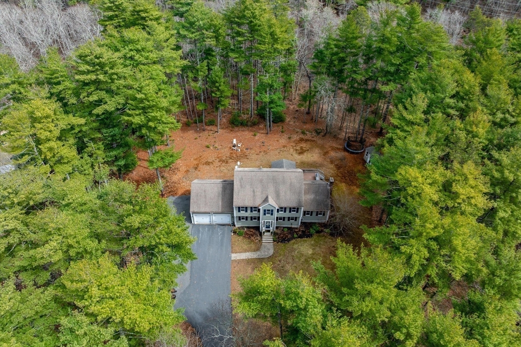 116 Meadow Street Carver, MA 02330 - Photo 37 of 42 an aerial view of a house with a yard lake and trees all around