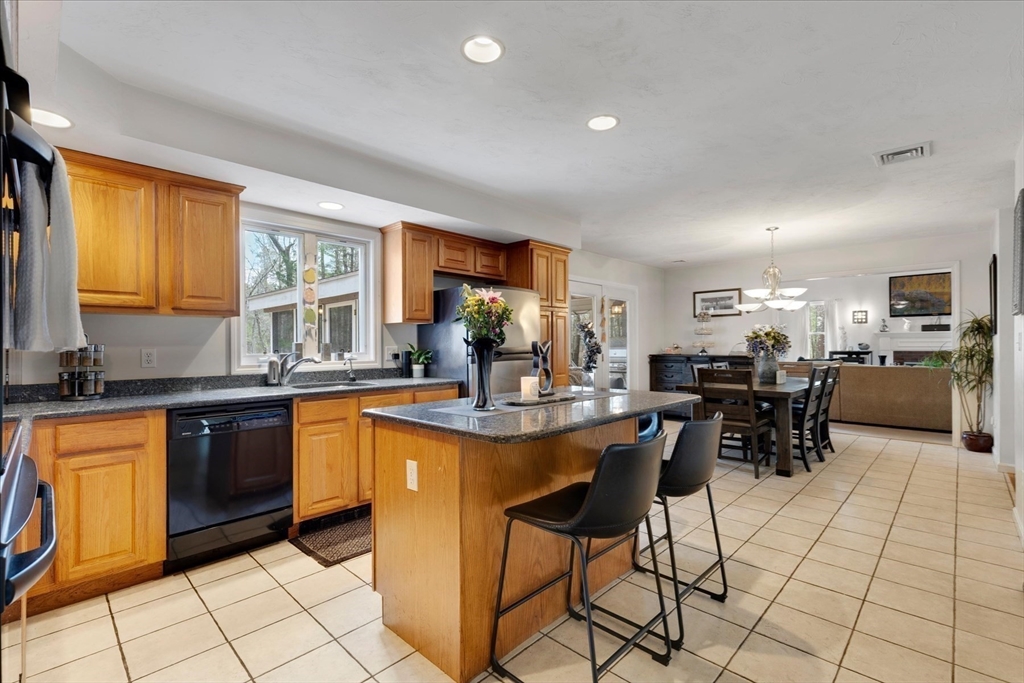 116 Meadow Street Carver, MA 02330 - Photo 9 of 42 a kitchen with stainless steel appliances kitchen island granite countertop a sink and cabinets