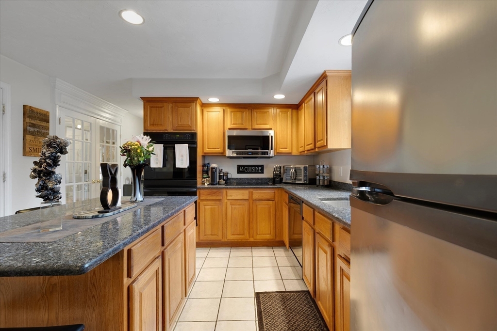 116 Meadow Street Carver, MA 02330 - Photo 10 of 42 a kitchen with stainless steel appliances granite countertop a sink stove and refrigerator