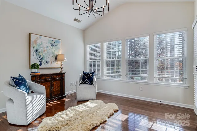 a living room with furniture two window and a rug