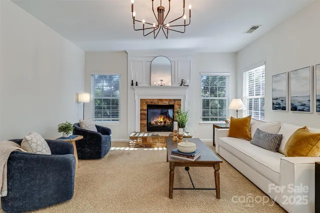 a living room with furniture a fireplace and a window