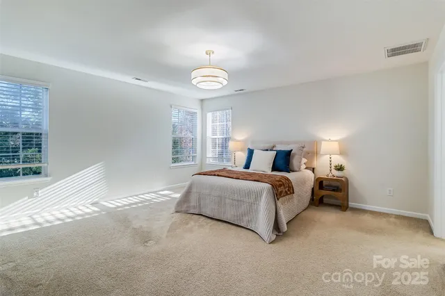 a bedroom with a bed and a large window