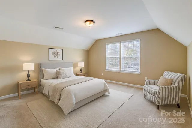 a bedroom with a bed and a couch