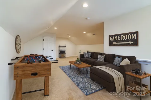 a living room with furniture and a dresser
