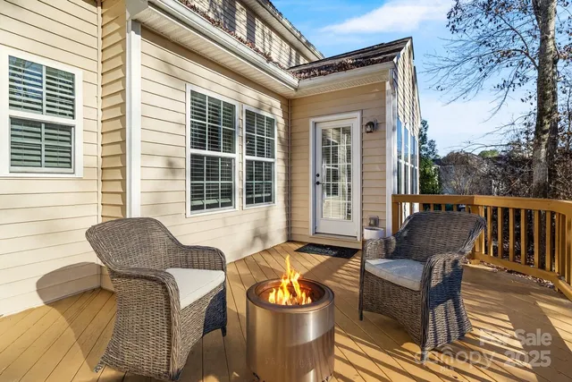 a view of a patio with couches chairs and wooden floor
