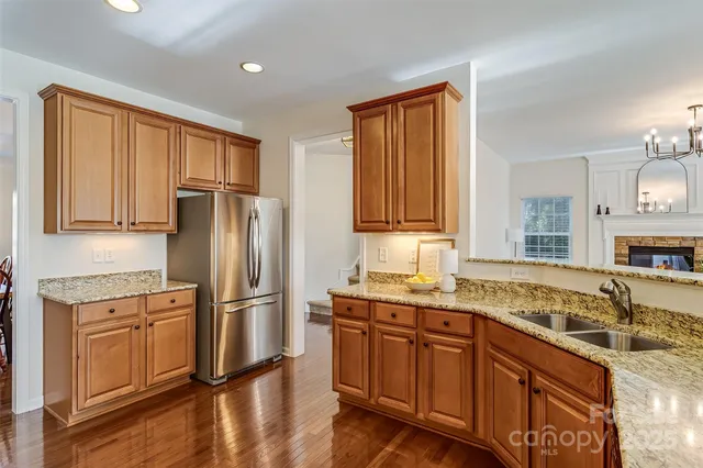 a kitchen with stainless steel appliances granite countertop a refrigerator sink and cabinets