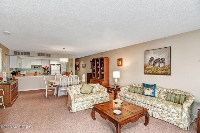 a living room with furniture a flat screen tv and a window