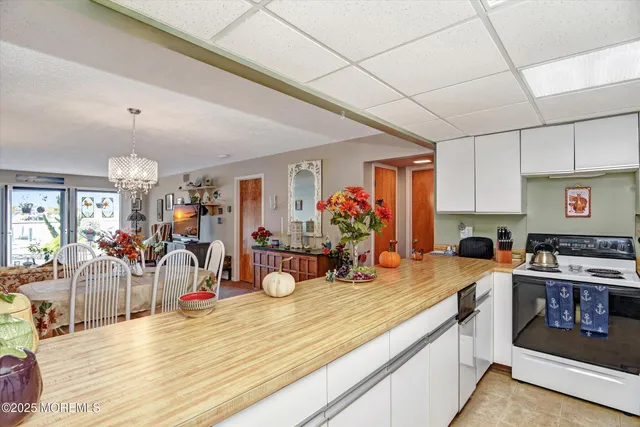a kitchen with stainless steel appliances kitchen island granite countertop a sink stove and cabinets