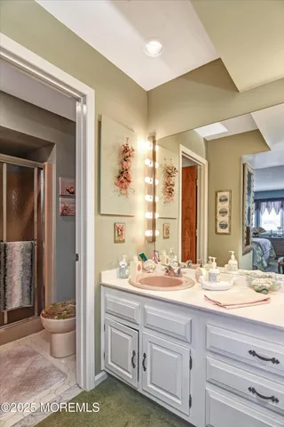 a bathroom with a glass shower door and a window