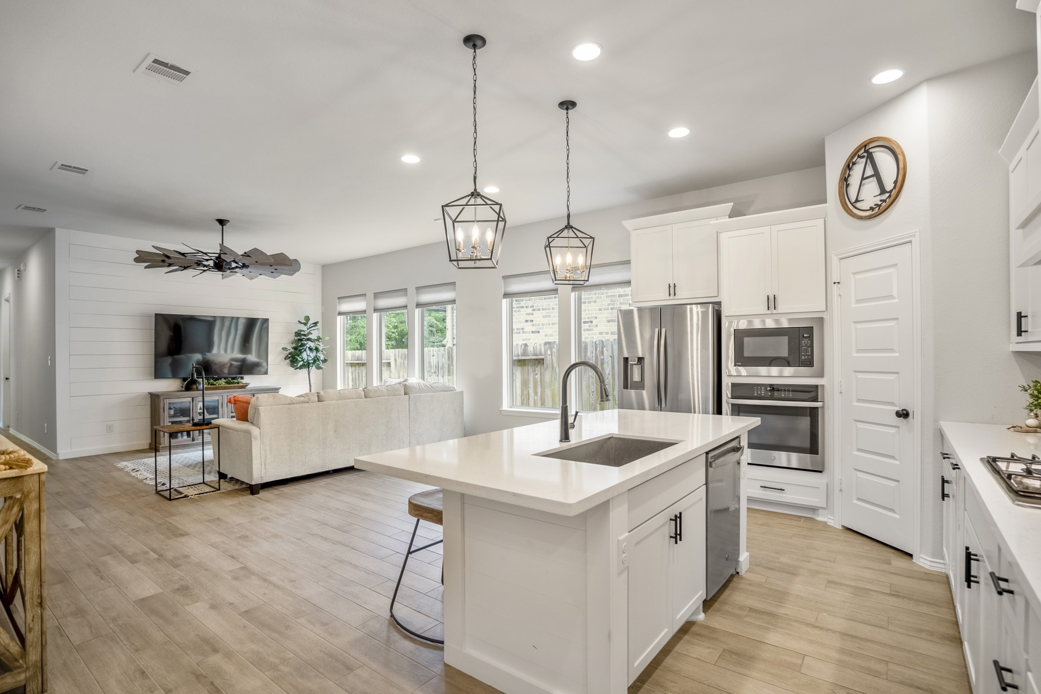 334 Topper Pines Drive Montgomery, TX 77316 - Photo 5 of 49 Stepping through the foyer round-a-bout we come to this magazine worthy view into the living spaces, showcasing the desirable open-concept design with the kitchen open to the dining area and living room.