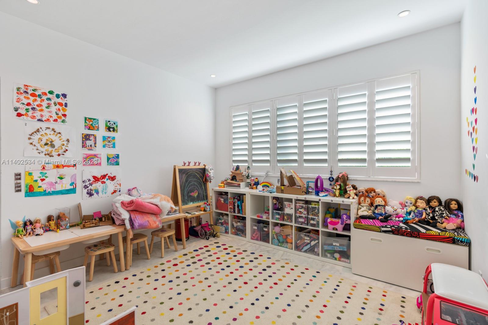 4741 Alton Road Miami Beach, FL 33140 - Photo 13 of 27 a room with furniture a rug toys and a window
