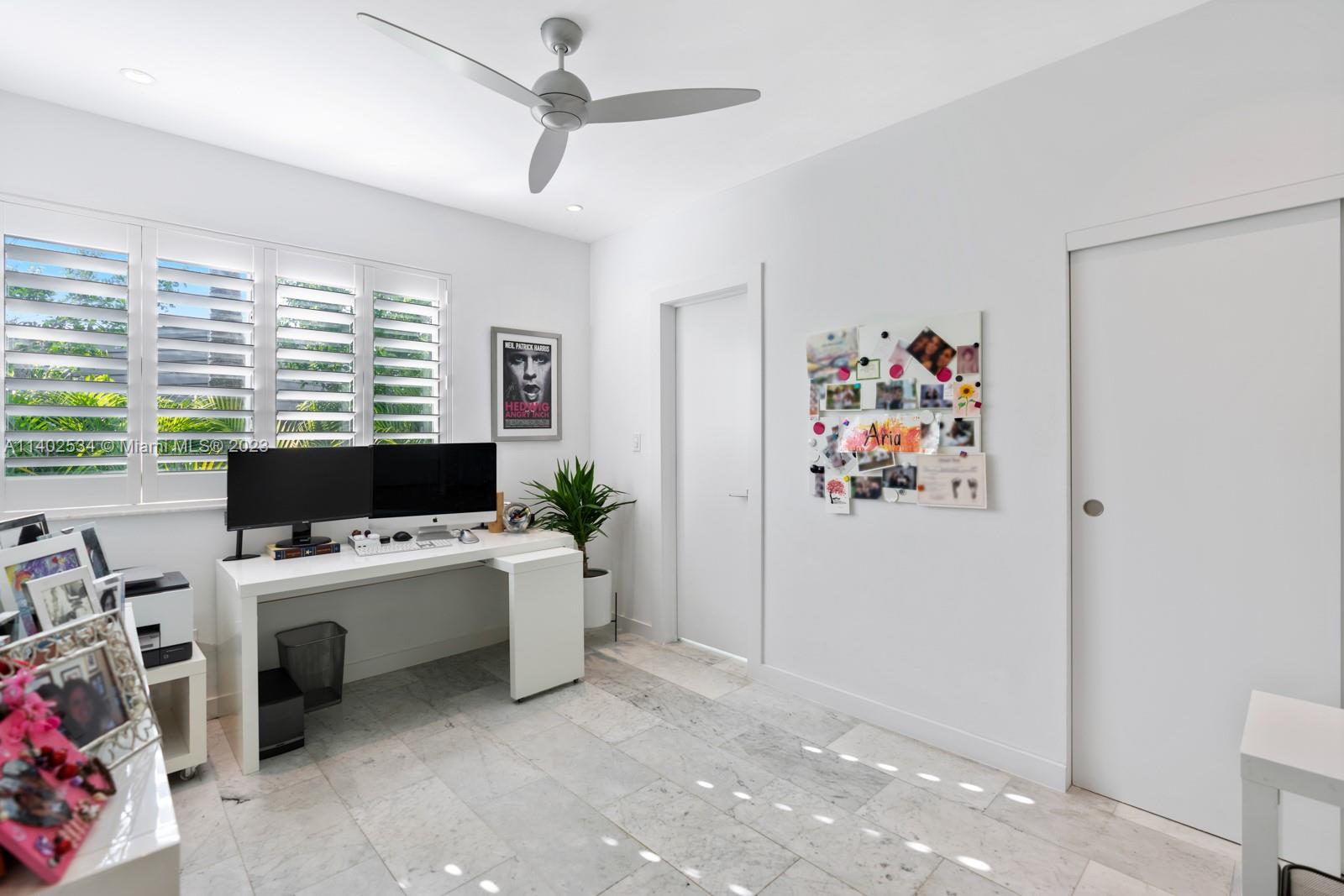 4741 Alton Road Miami Beach, FL 33140 - Photo 15 of 27 a view of a workspace with furniture and a window