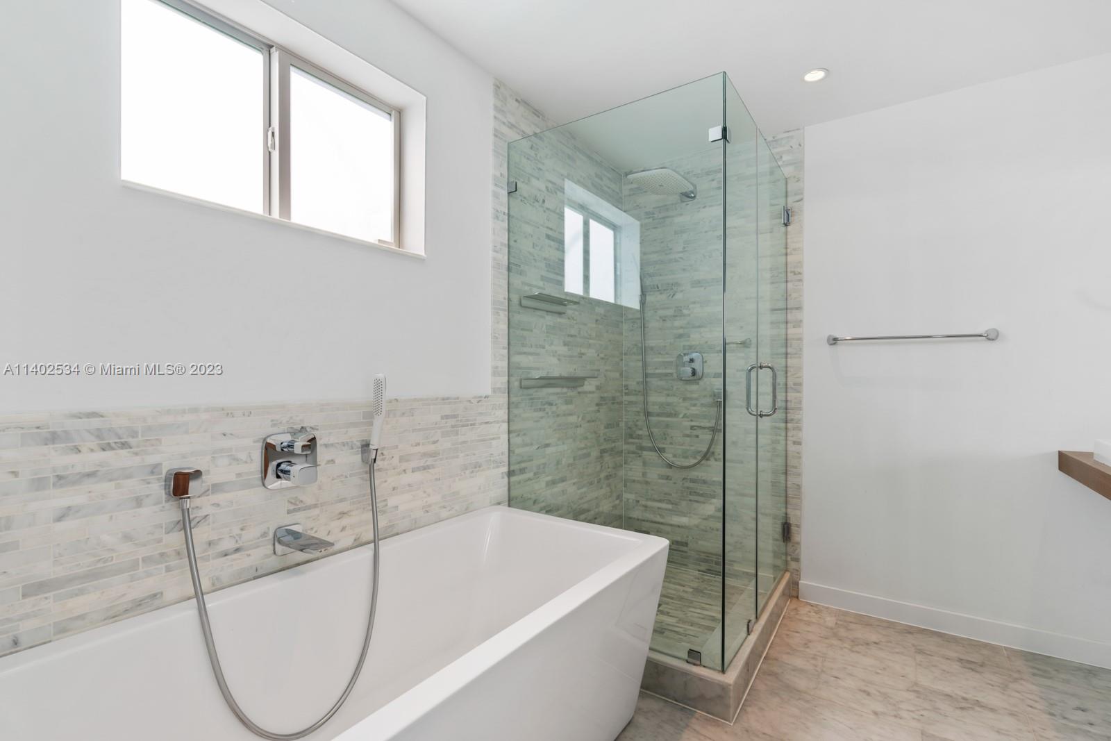 4741 Alton Road Miami Beach, FL 33140 - Photo 17 of 27 a bathroom with a bathtub and shower