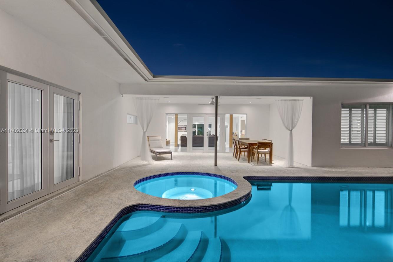 4741 Alton Road Miami Beach, FL 33140 - Photo 20 of 27 a view of a living room and dining room