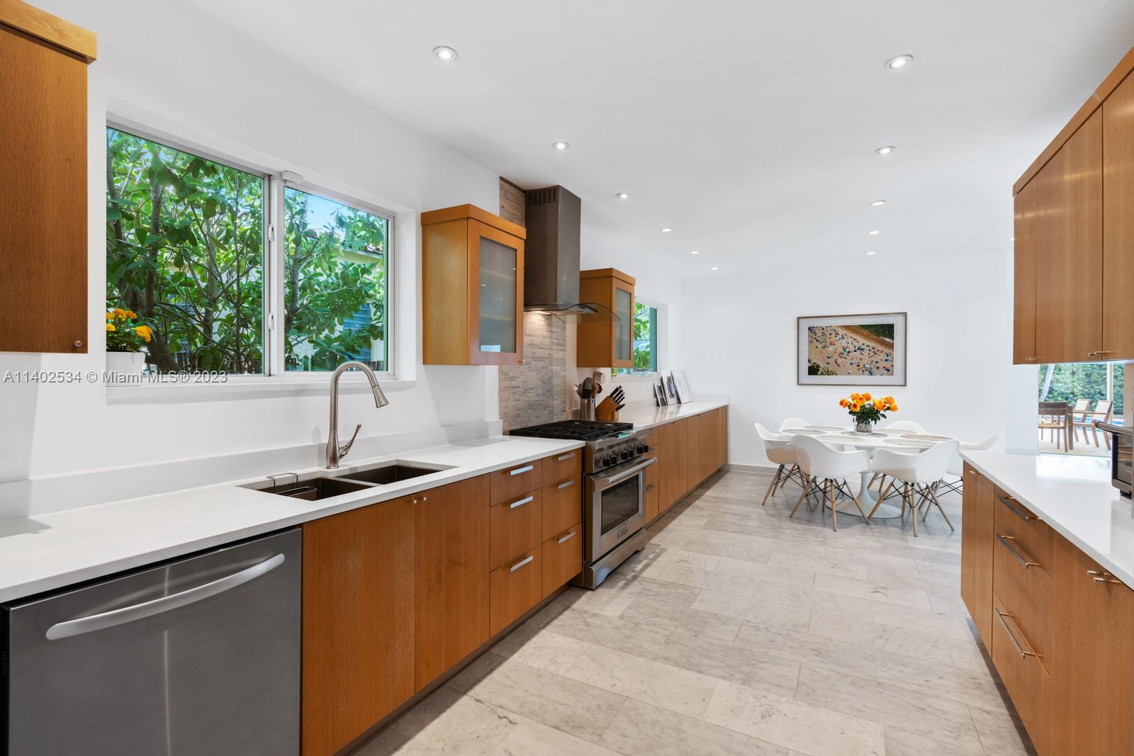 4741 Alton Road Miami Beach, FL 33140 - Photo 2 of 27 a kitchen with sink a counter top space and living room view