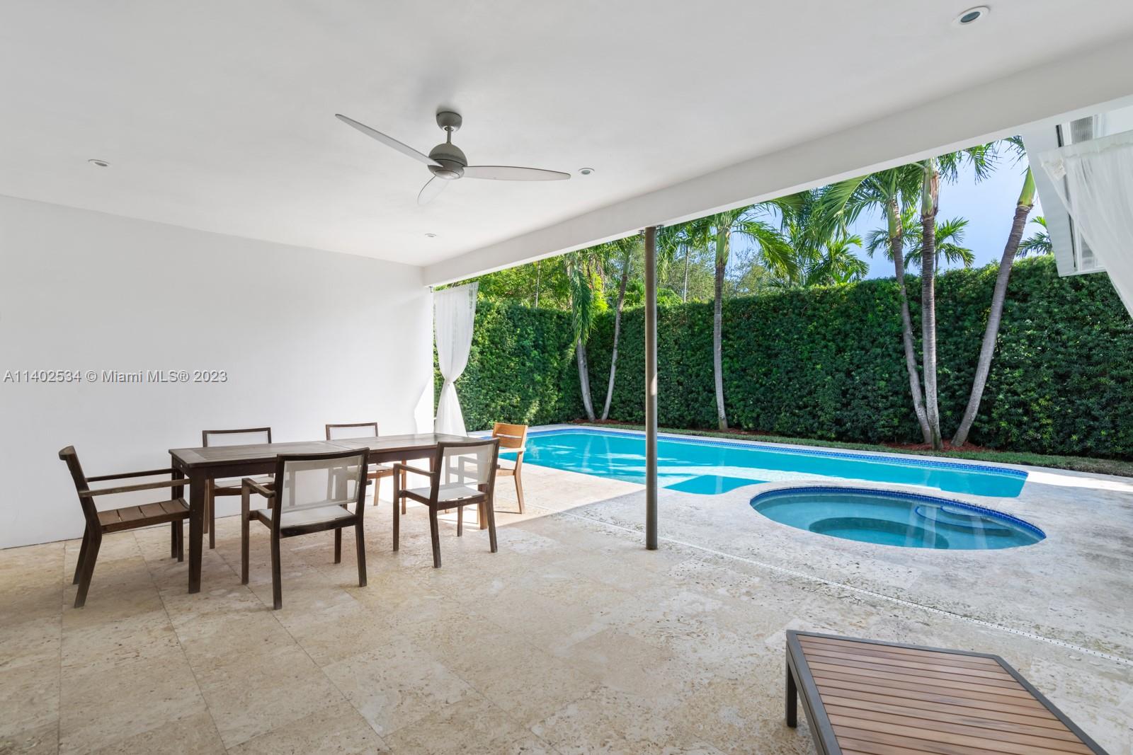 4741 Alton Road Miami Beach, FL 33140 - Photo 22 of 27 a view of a dining area with furniture window and outside view