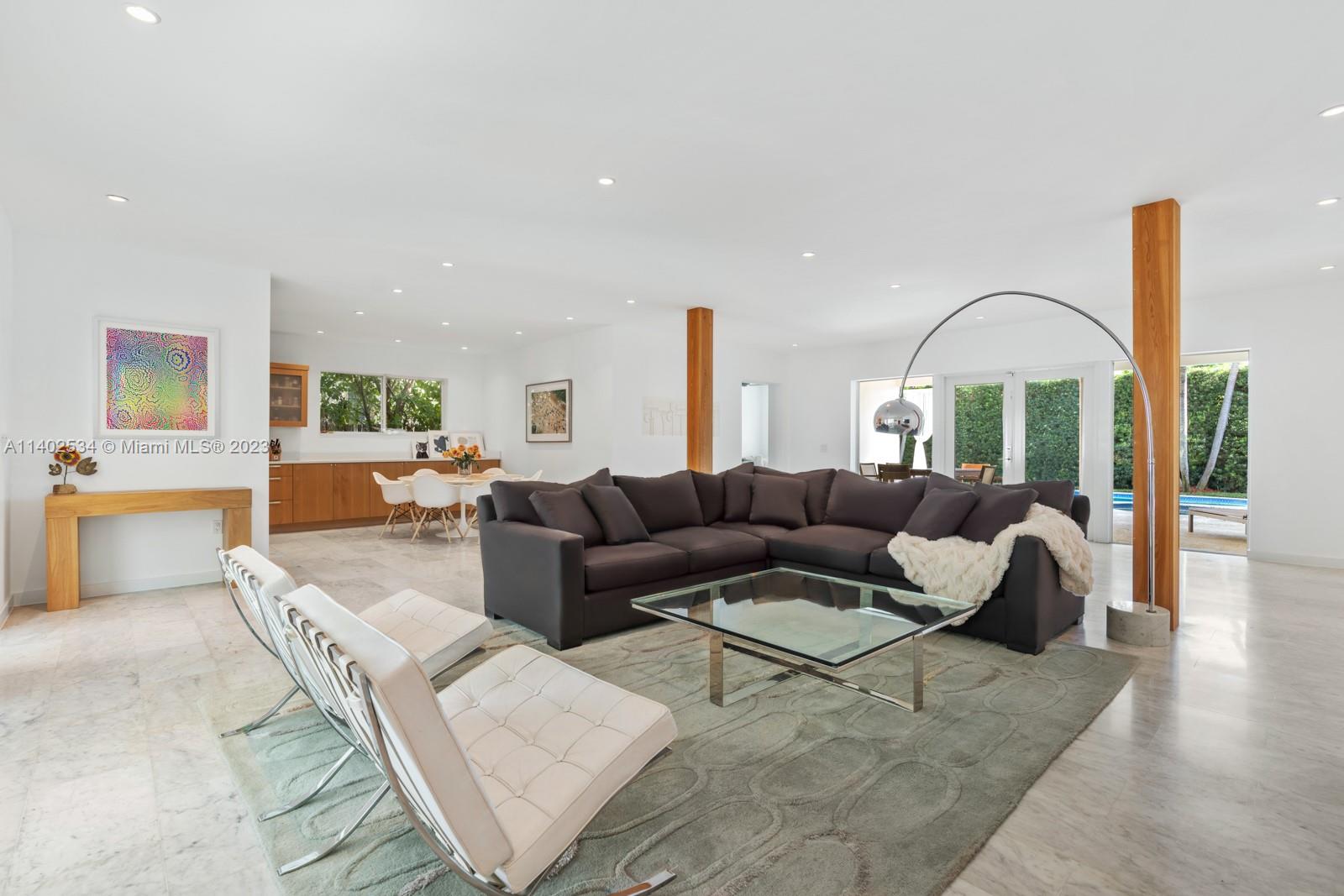 4741 Alton Road Miami Beach, FL 33140 - Photo 4 of 27 a living room with furniture and a chandelier