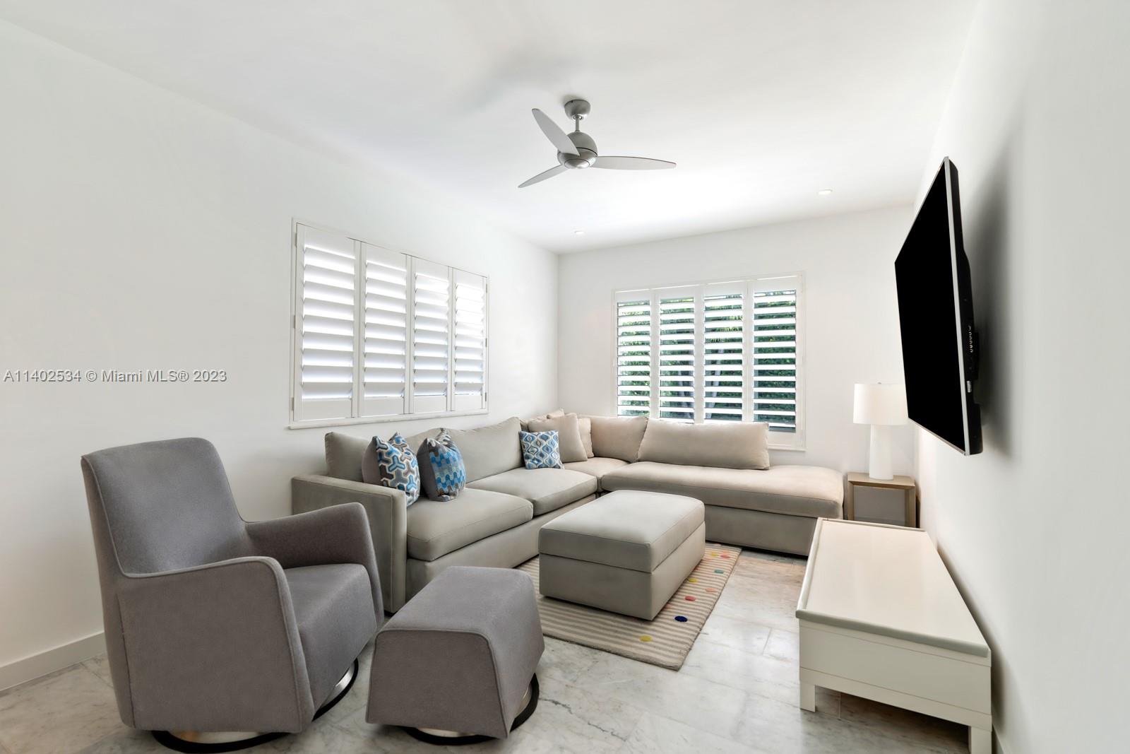 4741 Alton Road Miami Beach, FL 33140 - Photo 6 of 27 a living room with furniture and a flat screen tv