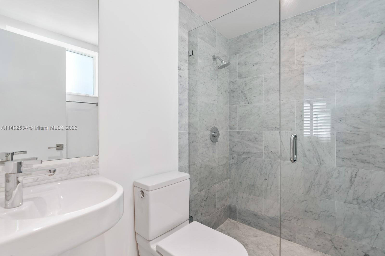 4741 Alton Road Miami Beach, FL 33140 - Photo 10 of 27 a bathroom with a sink toilet and shower