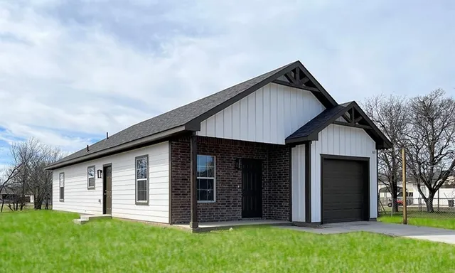 a front view of house with yard and green space