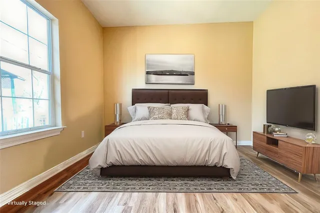 a bedroom with a bed and flat screen tv