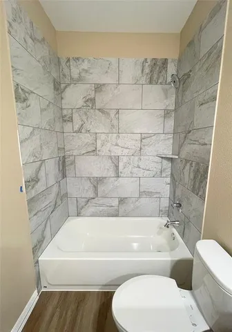 a bathroom with a bathtub and toilet