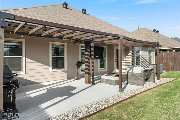 a view of a patio with table and chairs and potted plants