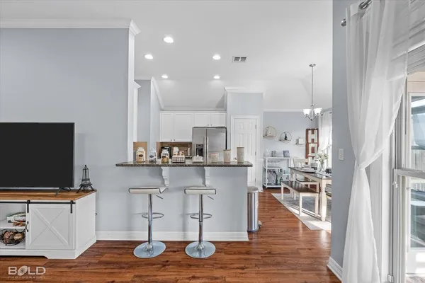 a kitchen with stainless steel appliances granite countertop a refrigerator stove microwave and sink