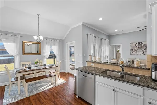 a kitchen with stainless steel appliances kitchen island granite countertop a refrigerator and a stove