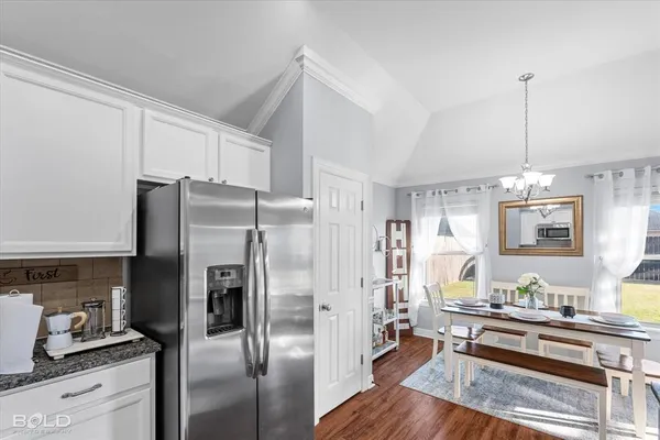 a living room with kitchen island furniture and a chandelier