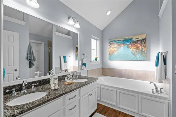 a bathroom with a bathtub and a sink