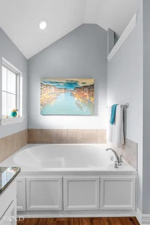 a bathroom with a tub and a shower