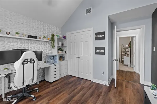a bathroom with a granite countertop toilet a sink a mirror a bathtub and shower