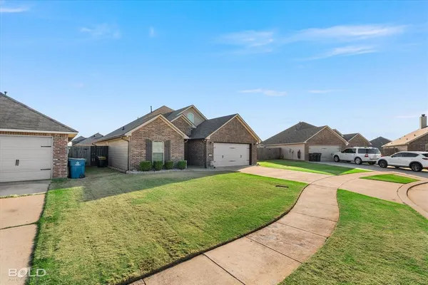 a view of a house with a big yard plants and large trees