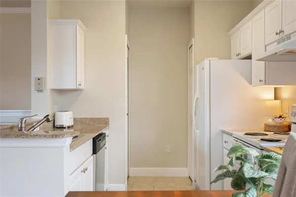 a kitchen with a refrigerator and a stove